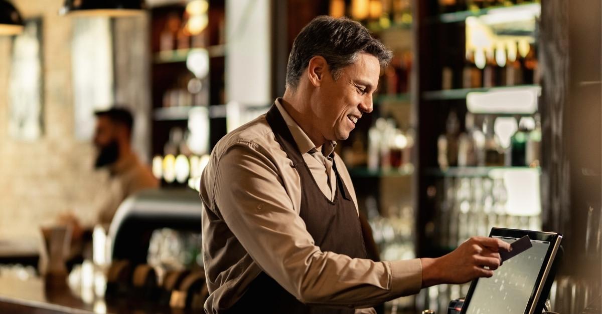restaurant-owner-processing-a-credit-card-payment-on-pos-system-in-new-york-city-ny